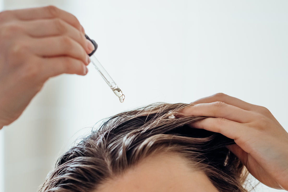 Serum wird mit Pipette in feuchtes Haar gegeben