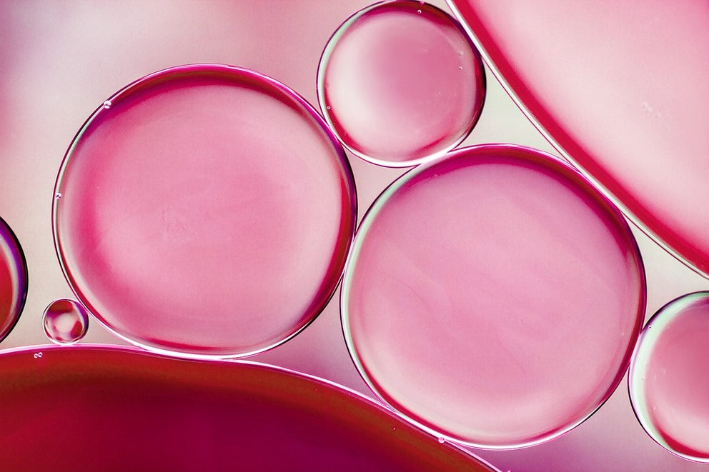 Makroaufnahme rosa Ölblasen auf hellem Hintergrund